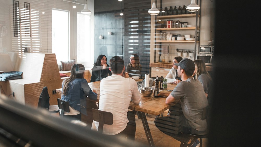 Several people talking at tables in a cafe